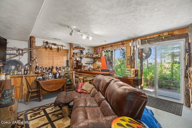17461 N Right Fork Rd, Hauser, ID 83854 - living area with a textured ceiling, rail lighting, and concrete floors