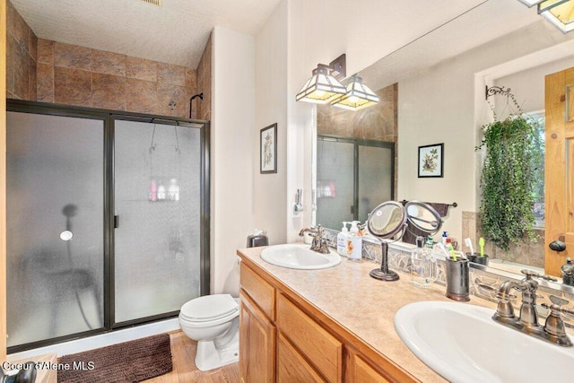 17461 N Right Fork Rd, Hauser, ID 83854 - full bath with a shower stall, toilet, double vanity, and wood finished floors
