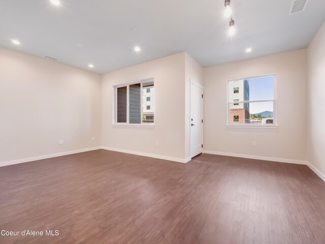 1008 E 4th Ave # 104, Post Falls, ID 83854 - unfurnished room with dark wood-style floors, recessed lighting, and baseboards