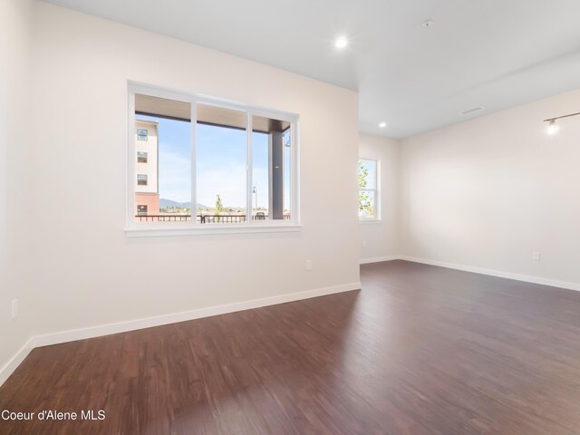 1008 E 4th Ave # 104, Post Falls, ID 83854 - spare room with dark wood finished floors, baseboards, and recessed lighting