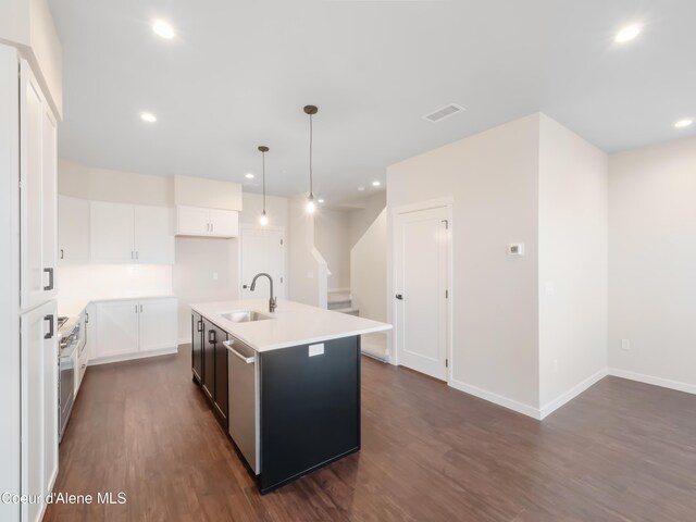 1008 E 4th Ave # 104, Post Falls, ID 83854 - kitchen with a sink, dark wood finished floors, dishwasher, a center island with sink, and light countertops
