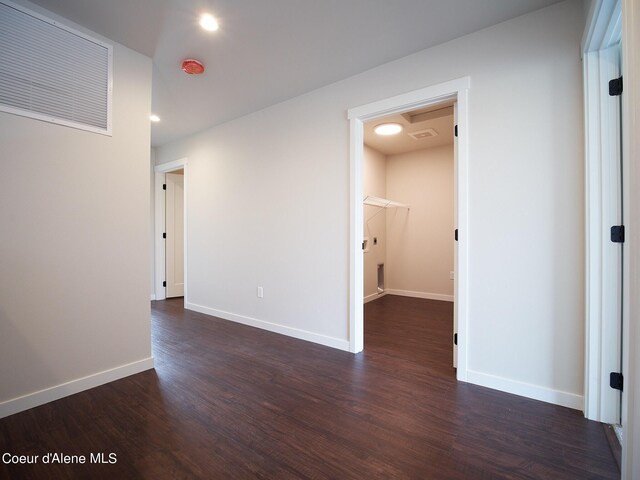 1008 E 4th Ave # 104, Post Falls, ID 83854 - unfurnished room featuring dark wood-style flooring, baseboards, and recessed lighting