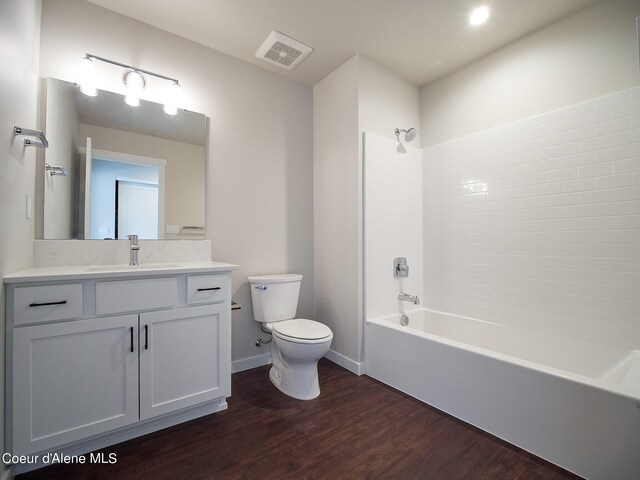 1008 E 4th Ave # 104, Post Falls, ID 83854 - bathroom featuring toilet, vanity, shower / bath combination, wood finished floors, and baseboards