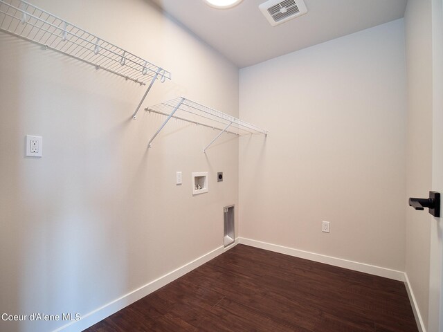 1008 E 4th Ave # 104, Post Falls, ID 83854 - laundry room with electric dryer hookup, hookup for a washing machine, baseboards, and dark wood-style floors
