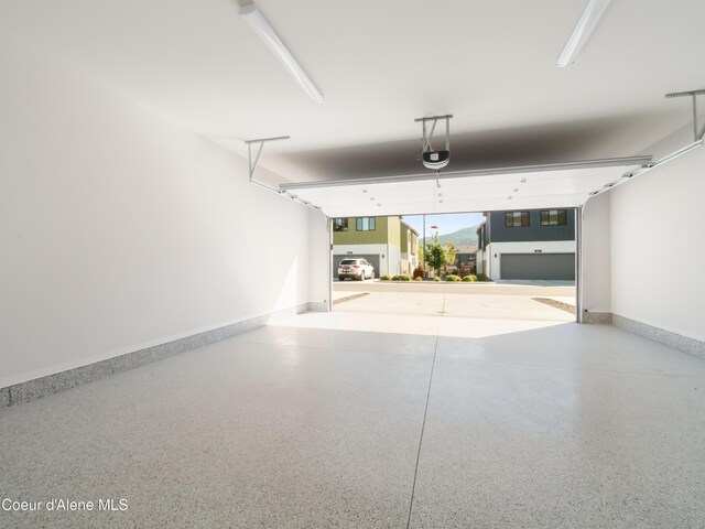 1008 E 4th Ave # 104, Post Falls, ID 83854 - garage with a garage door opener and baseboards