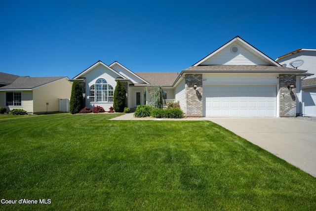 2619 N Tiatan St, Post Falls, ID 83854 - ranch-style house featuring concrete driveway, a front lawn, an attached garage, and brick siding