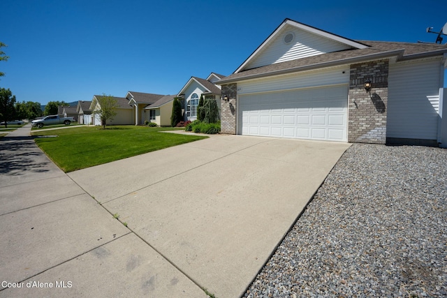 2619 N Tiatan St, Post Falls, ID 83854 - ranch-style home featuring concrete driveway, a garage, a front yard, and brick siding