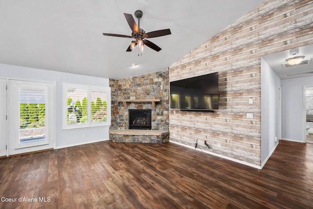2619 N Tiatan St, Post Falls, ID 83854 - unfurnished living room with lofted ceiling, a ceiling fan, a fireplace, wood finished floors, and wooden walls