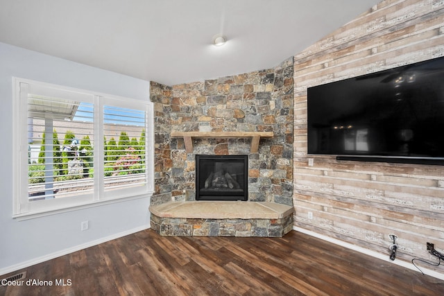 2619 N Tiatan St, Post Falls, ID 83854 - living area featuring vaulted ceiling, a fireplace, wood finished floors, and baseboards