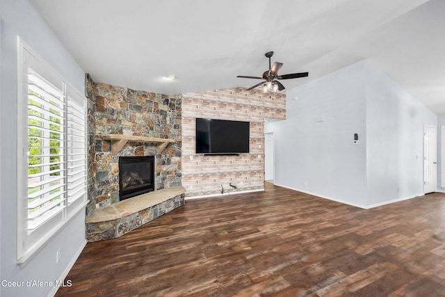 2619 N Tiatan St, Post Falls, ID 83854 - unfurnished living room featuring a fireplace, wood finished floors, vaulted ceiling, ceiling fan, and baseboards