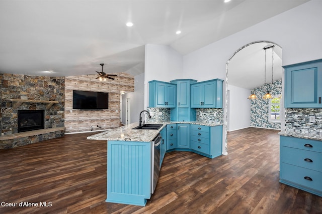 2619 N Tiatan St, Post Falls, ID 83854 - kitchen with a sink, open floor plan, a peninsula, blue cabinets, and a ceiling fan