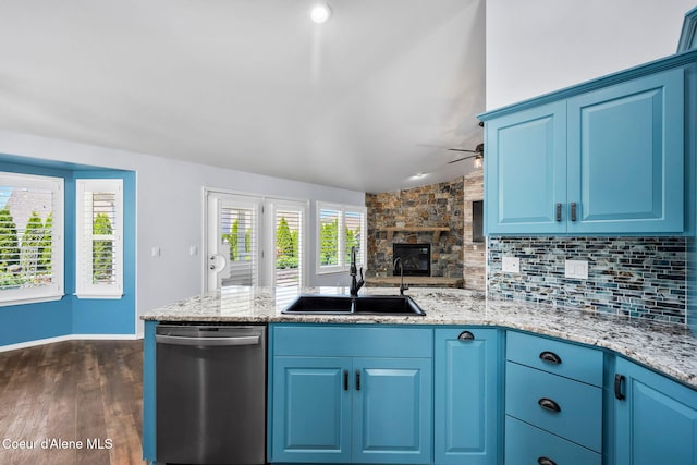 2619 N Tiatan St, Post Falls, ID 83854 - kitchen featuring dishwasher, a sink, a ceiling fan, a peninsula, and blue cabinetry