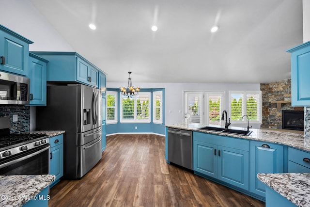 2619 N Tiatan St, Post Falls, ID 83854 - kitchen featuring stainless steel appliances, a sink, dark wood-type flooring, a chandelier, and blue cabinetry