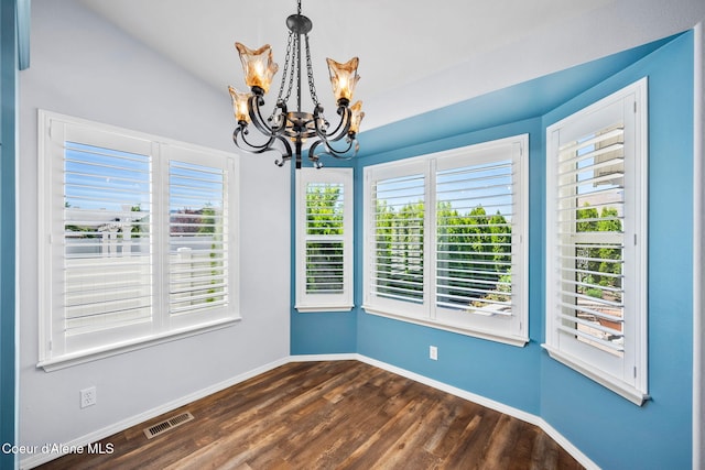 2619 N Tiatan St, Post Falls, ID 83854 - unfurnished dining area with a chandelier, dark wood-style flooring, and baseboards