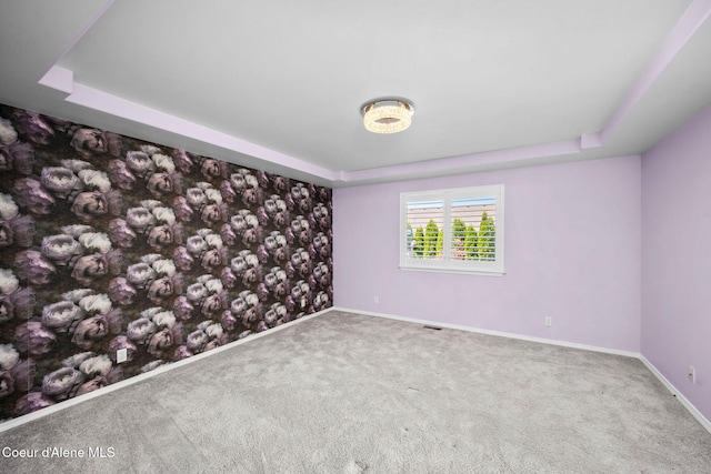 2619 N Tiatan St, Post Falls, ID 83854 - empty room featuring a tray ceiling, baseboards, and carpet floors