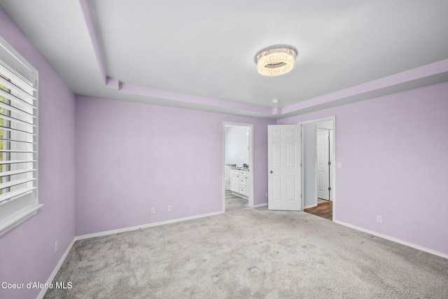 2619 N Tiatan St, Post Falls, ID 83854 - unfurnished bedroom featuring carpet flooring, baseboards, and a tray ceiling