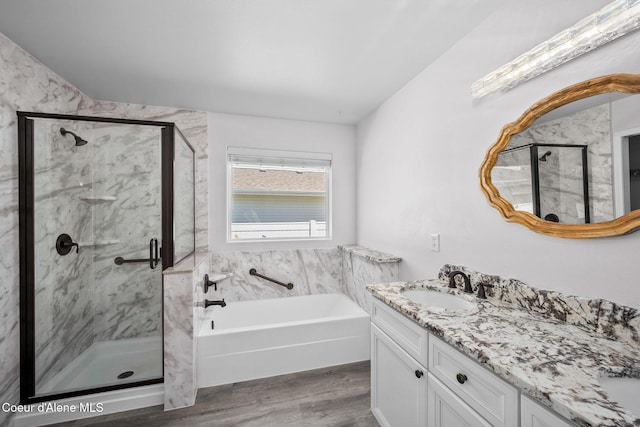 2619 N Tiatan St, Post Falls, ID 83854 - bathroom with a bath, vanity, wood finished floors, and a stall shower