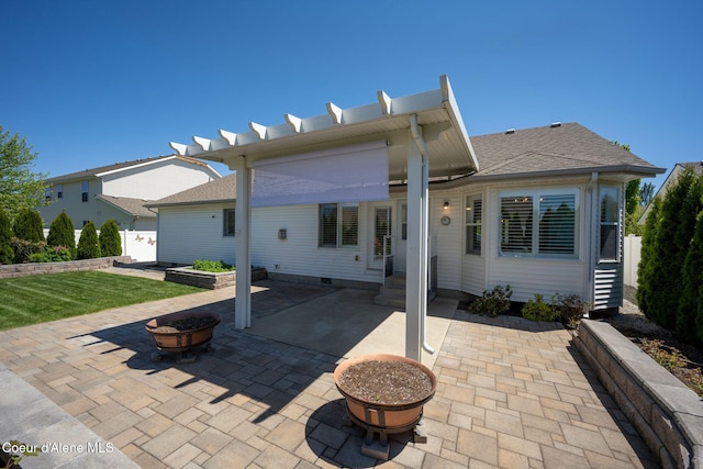 2619 N Tiatan St, Post Falls, ID 83854 - back of property with a patio, a yard, roof with shingles, and an outdoor fire pit