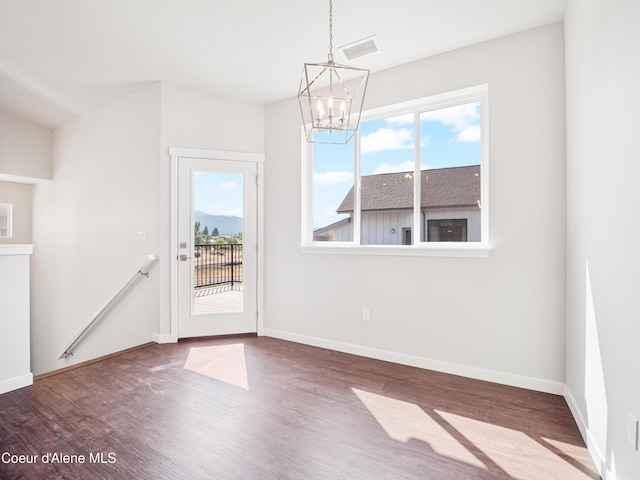 928 E Railroad Ave, Post Falls, ID 83854 - unfurnished dining area with a chandelier, wood finished floors, and baseboards