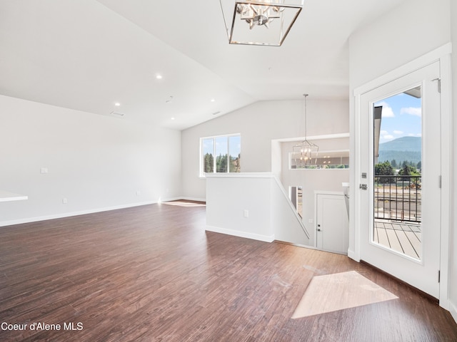 928 E Railroad Ave, Post Falls, ID 83854 - foyer entrance featuring a chandelier, vaulted ceiling, wood finished floors, and baseboards