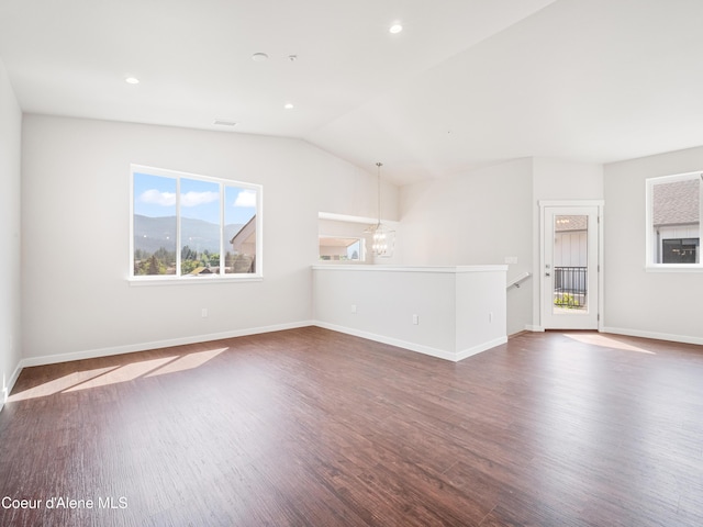 928 E Railroad Ave, Post Falls, ID 83854 - unfurnished living room with dark wood finished floors, a chandelier, baseboards, lofted ceiling, and recessed lighting