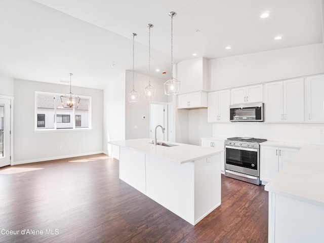 928 E Railroad Ave, Post Falls, ID 83854 - kitchen featuring appliances with stainless steel finishes, a sink, dark wood finished floors, light countertops, and a chandelier