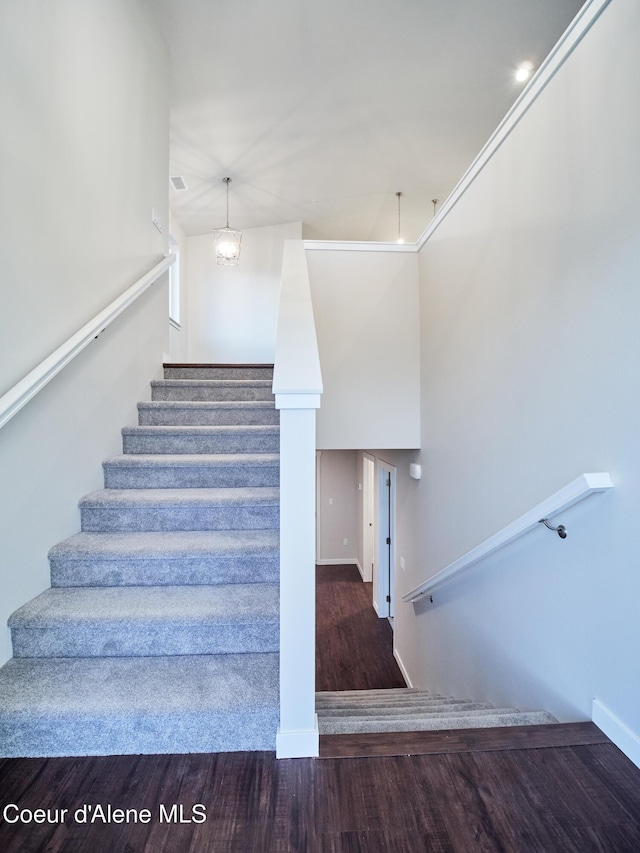 928 E Railroad Ave, Post Falls, ID 83854 - staircase featuring wood finished floors, baseboards, and a chandelier