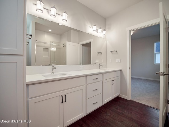 928 E Railroad Ave, Post Falls, ID 83854 - full bath with double vanity, a stall shower, baseboards, and wood finished floors