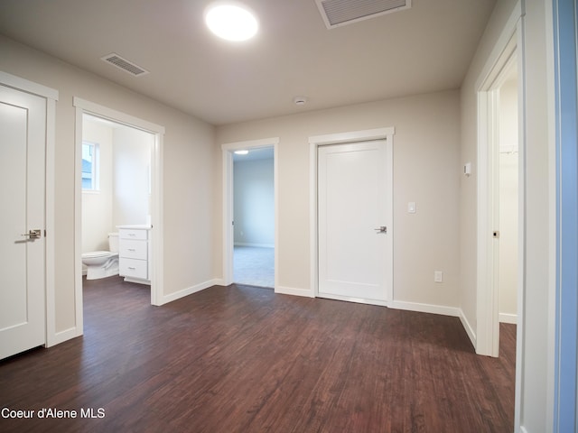 928 E Railroad Ave, Post Falls, ID 83854 - unfurnished bedroom featuring dark wood-style floors, baseboards, and ensuite bath
