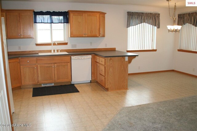 1601 Sequoia St, Sandpoint, ID 83864 - kitchen featuring white appliances, a sink, a peninsula, a chandelier, and light floors