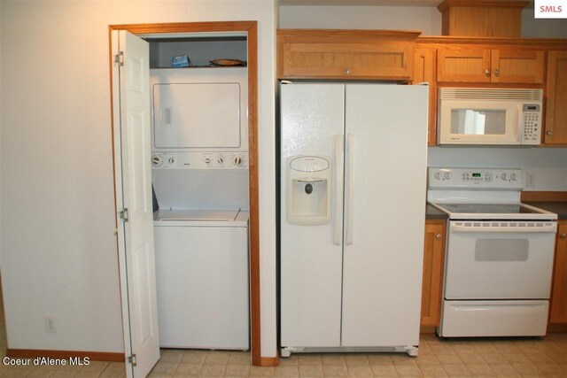 1601 Sequoia St, Sandpoint, ID 83864 - kitchen with white appliances, stacked washer / drying machine, and brown cabinets