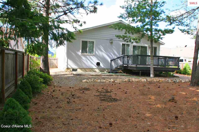 1601 Sequoia St, Sandpoint, ID 83864 - rear view of house featuring a fenced backyard, a deck, and crawl space