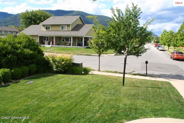 1601 Sequoia St, Sandpoint, ID 83864 - view of grassy yard featuring a mountain view and covered porch