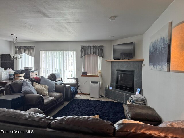 1601 Sequoia St, Sandpoint, ID 83864 - carpeted living area featuring a fireplace and a chandelier
