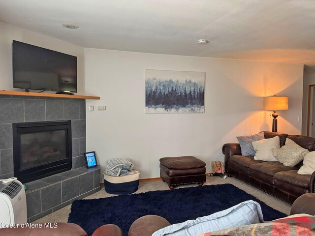 1601 Sequoia St, Sandpoint, ID 83864 - carpeted living room featuring a tiled fireplace and baseboards