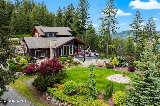 295 Sky Meadow Ln, Sagle, ID 83860 - rear view of property with a forest view, a lawn, and a deck with mountain view