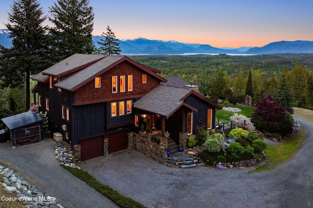 295 Sky Meadow Ln, Sagle, ID 83860 - chalet / cabin with gravel driveway, a mountain view, a wooded view, stone siding, and a shingled roof