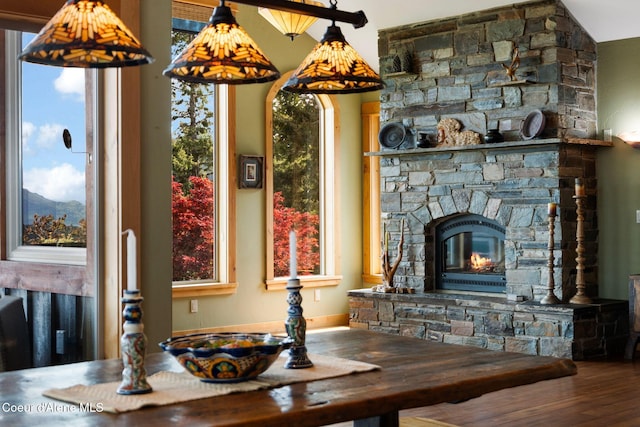 295 Sky Meadow Ln, Sagle, ID 83860 - dining area with healthy amount of natural light, wood finished floors, and a stone fireplace