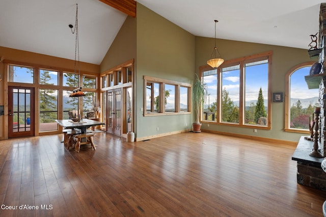 295 Sky Meadow Ln, Sagle, ID 83860 - dining space featuring high vaulted ceiling, wood finished floors, baseboards, and beamed ceiling