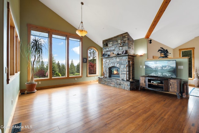 295 Sky Meadow Ln, Sagle, ID 83860 - unfurnished living room with hardwood / wood-style floors, a stone fireplace, beam ceiling, and high vaulted ceiling