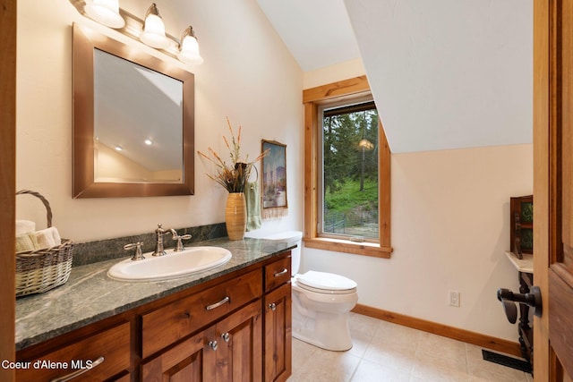295 Sky Meadow Ln, Sagle, ID 83860 - bathroom featuring vaulted ceiling, vanity, toilet, and baseboards