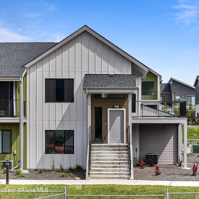 998 E Railroad Ave, Post Falls, ID 83854 - view of front facade with board and batten siding, central AC, and a shingled roof