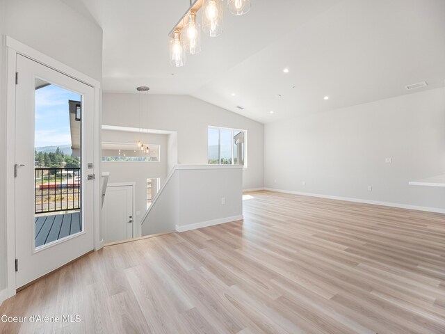 998 E Railroad Ave, Post Falls, ID 83854 - unfurnished living room featuring a chandelier, lofted ceiling, light wood finished floors, baseboards, and recessed lighting