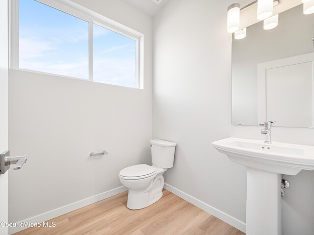 998 E Railroad Ave, Post Falls, ID 83854 - bathroom with toilet, baseboards, and wood finished floors
