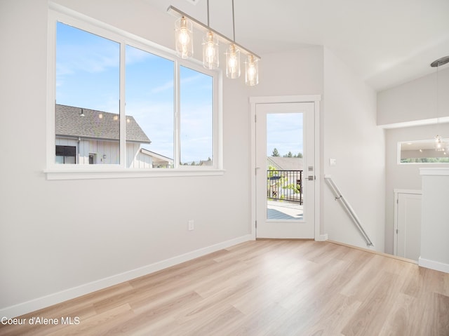 998 E Railroad Ave, Post Falls, ID 83854 - unfurnished dining area featuring wood finished floors, baseboards, and a chandelier