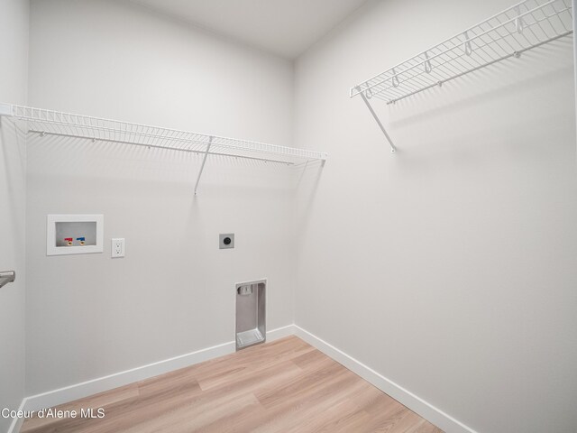 998 E Railroad Ave, Post Falls, ID 83854 - laundry area featuring hookup for an electric dryer, hookup for a washing machine, light wood-style floors, and baseboards