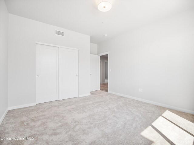 998 E Railroad Ave, Post Falls, ID 83854 - unfurnished bedroom featuring carpet flooring, a closet, and baseboards