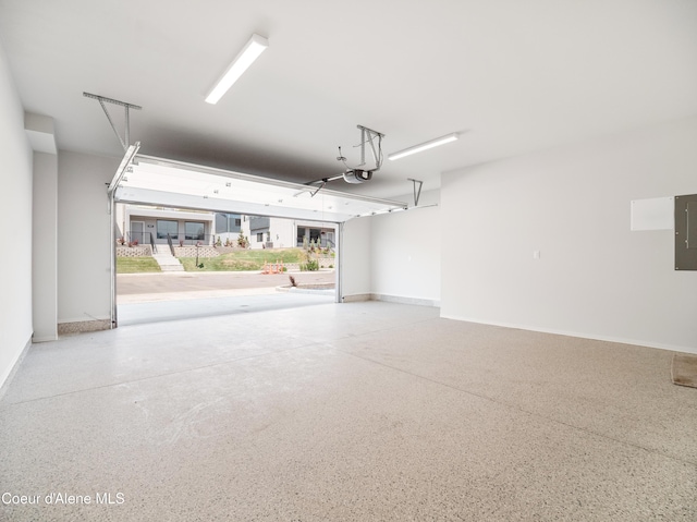 998 E Railroad Ave, Post Falls, ID 83854 - garage featuring a garage door opener, electric panel, and baseboards