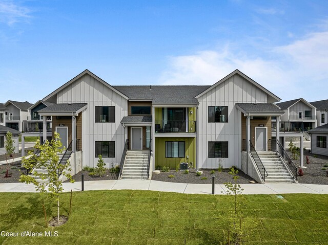 998 E Railroad Ave, Post Falls, ID 83854 - view of front of home with board and batten siding, stairs, a front yard, and a shingled roof