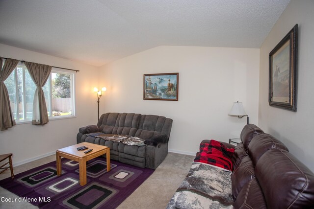 3420 E Poleline Ave, Post Falls, ID 83854 - living area with lofted ceiling, carpet flooring, and baseboards